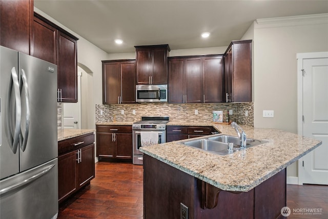 2413 Peabody St, Bellingham, WA 98225 - kitchen with stainless steel appliances, a peninsula, dark wood finished floors, a sink, and a breakfast bar