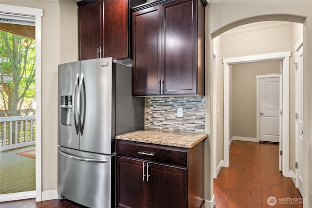 2413 Peabody St, Bellingham, WA 98225 - kitchen with stainless steel fridge with ice dispenser, backsplash, arched walkways, dark wood-style flooring, and light stone counters