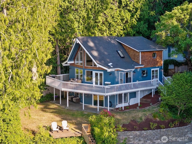 19709 Whiteman Cove Rd SW, Longbranch, WA 98351 - rear view of property featuring a wooden deck, a patio area, and stairway