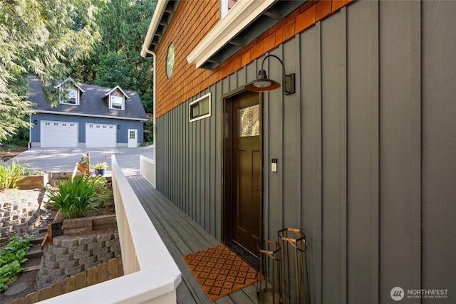 19709 Whiteman Cove Rd SW, Longbranch, WA 98351 - view of home's exterior with an outbuilding, a garage, and board and batten siding
