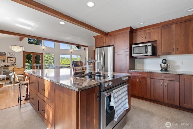 19709 Whiteman Cove Rd SW, Longbranch, WA 98351 - kitchen featuring appliances with stainless steel finishes, beam ceiling, brown cabinets, stone countertops, and recessed lighting