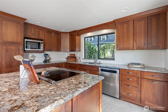 19709 Whiteman Cove Rd SW, Longbranch, WA 98351 - kitchen with stainless steel appliances, brown cabinets, light stone counters, and recessed lighting