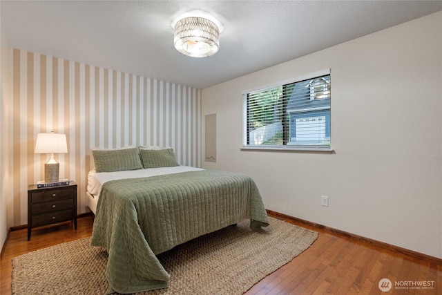 19709 Whiteman Cove Rd SW, Longbranch, WA 98351 - bedroom with baseboards and hardwood / wood-style floors