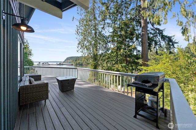 19709 Whiteman Cove Rd SW, Longbranch, WA 98351 - wooden terrace featuring a water view and grilling area
