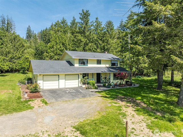 29139 NE Hammond Ct, Battle Ground, WA 98604 - traditional-style home featuring an attached garage, driveway, a front lawn, and a wooded view