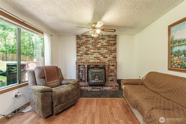 29139 NE Hammond Ct, Battle Ground, WA 98604 - living area with wood finished floors, ceiling fan, a textured ceiling, and a wood stove