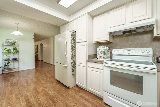 29139 NE Hammond Ct, Battle Ground, WA 98604 - kitchen featuring white appliances, under cabinet range hood, light wood finished floors, white cabinets, and arched walkways