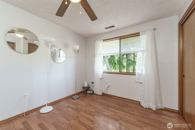 29139 NE Hammond Ct, Battle Ground, WA 98604 - empty room with a textured ceiling, light wood-style flooring, a ceiling fan, and baseboards