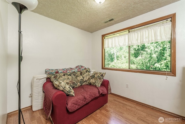 29139 NE Hammond Ct, Battle Ground, WA 98604 - living area with a textured ceiling, wood finished floors, and baseboards