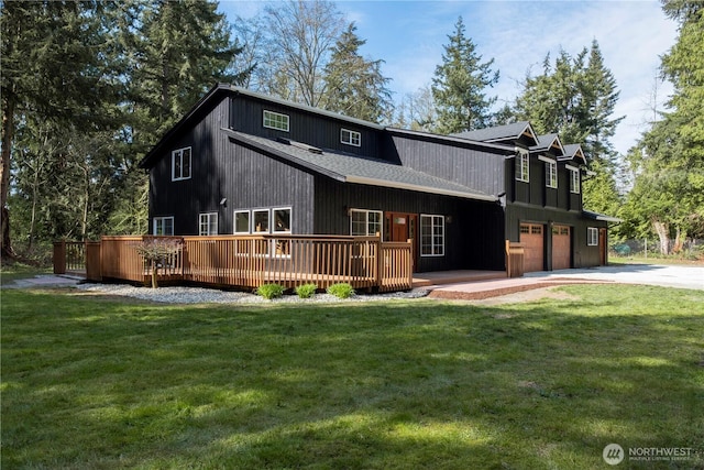435 Thumper Ln, Camano Island, WA 98282 - view of front facade featuring a garage, driveway, a front lawn, and a wooden deck