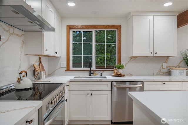435 Thumper Ln, Camano Island, WA 98282 - kitchen featuring appliances with stainless steel finishes, a sink, range hood, white cabinetry, and recessed lighting