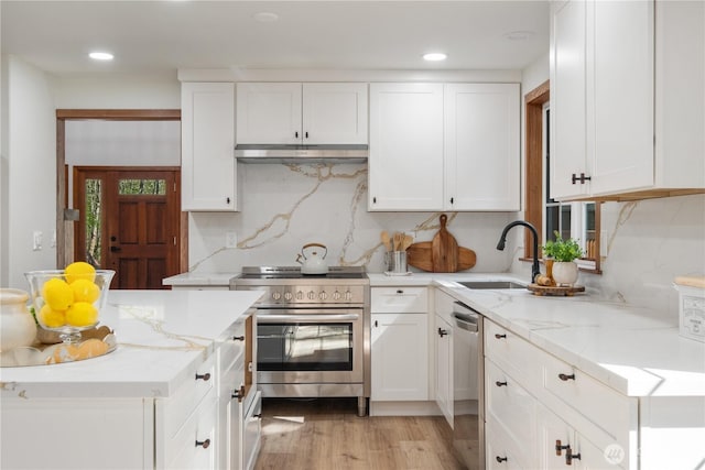 435 Thumper Ln, Camano Island, WA 98282 - kitchen with stainless steel appliances, a sink, under cabinet range hood, white cabinetry, and recessed lighting