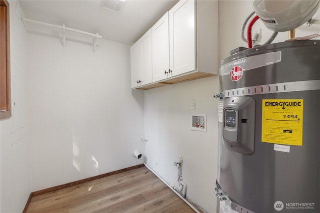 435 Thumper Ln, Camano Island, WA 98282 - washroom with secured water heater, cabinet space, hookup for a washing machine, hookup for a gas dryer, and light wood-type flooring