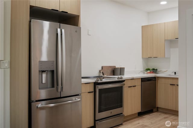 435 Thumper Ln, Camano Island, WA 98282 - kitchen featuring stainless steel appliances, light brown cabinets, light wood-type flooring, and modern cabinets