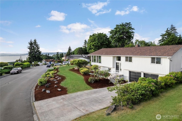 28830 11th Ave S, Federal Way, WA 98003 - raised ranch with a garage, concrete driveway, a front lawn, and roof with shingles