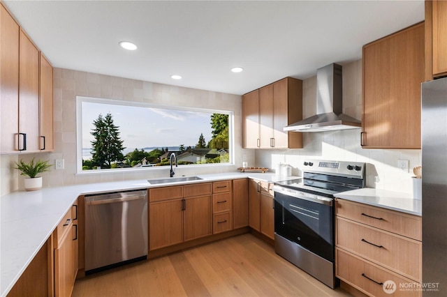 28830 11th Ave S, Federal Way, WA 98003 - kitchen featuring stainless steel appliances, wall chimney range hood, a sink, light wood-type flooring, and light countertops