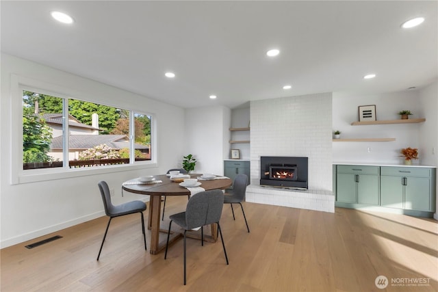 28830 11th Ave S, Federal Way, WA 98003 - dining space with light wood finished floors, a fireplace, baseboards, and recessed lighting