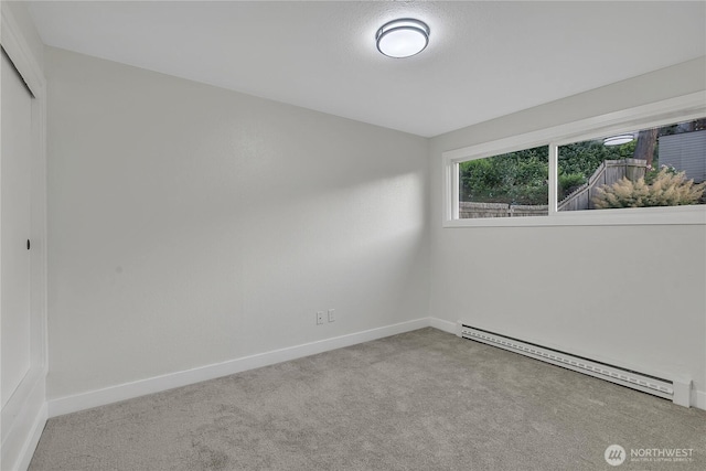 10209 65th Ave S, Seattle, WA 98178 - carpeted empty room featuring baseboard heating and baseboards