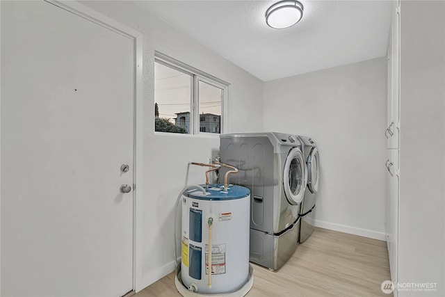 10209 65th Ave S, Seattle, WA 98178 - laundry area with washing machine and dryer, water heater, light wood-type flooring, and baseboards