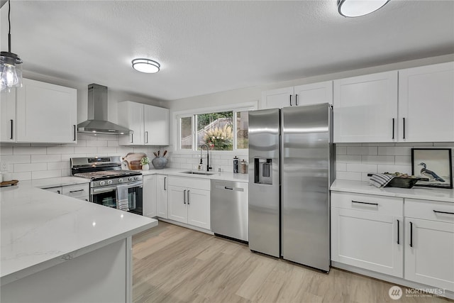 10209 65th Ave S, Seattle, WA 98178 - kitchen with wall chimney exhaust hood, stainless steel appliances, a sink, tasteful backsplash, and a textured ceiling