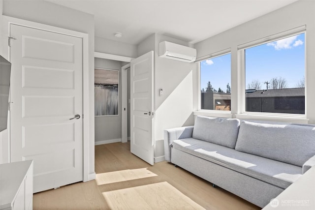 3638 36th Ave S Unit D, Seattle, WA 98144 - living room with a wall mounted air conditioner, light wood-type flooring, and baseboards