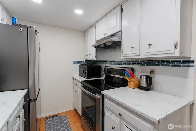 1801 Evergreen Park Ct SW Unit 8, Olympia, WA 98502 - kitchen featuring appliances with stainless steel finishes, under cabinet range hood, backsplash, light wood-style floors, and white cabinetry