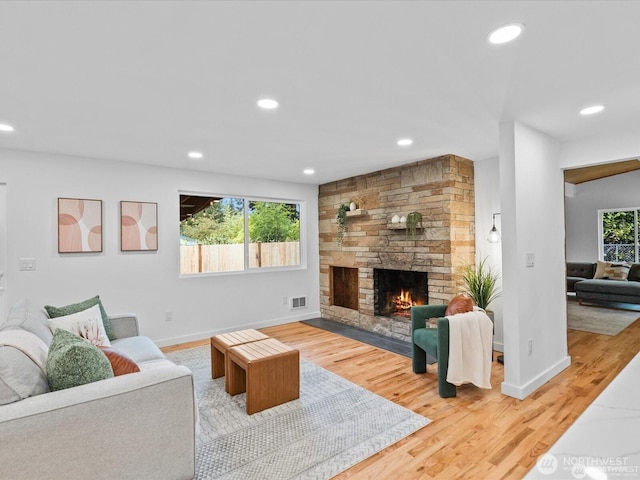 8421 240th St SW, Edmonds, WA 98020 - living room with light wood finished floors, a stone fireplace, baseboards, and recessed lighting