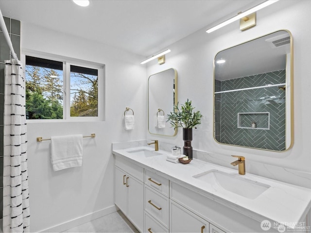 8421 240th St SW, Edmonds, WA 98020 - bathroom featuring double vanity, tiled shower, baseboards, and tile patterned floors