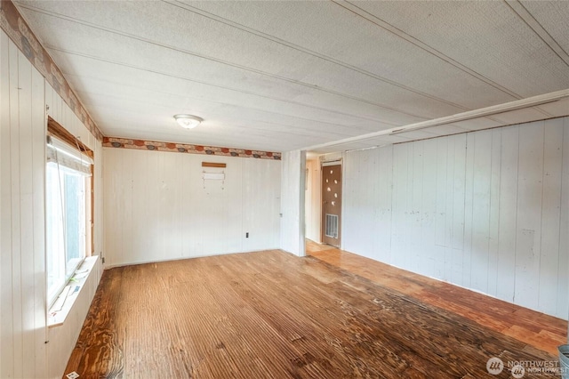 7503 189th Street Ct E Unit 12, Puyallup, WA 98375 - empty room featuring wood finished floors and wood walls