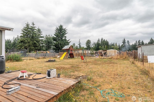 7503 189th Street Ct E Unit 12, Puyallup, WA 98375 - fenced backyard with a playground, a trampoline, and a deck