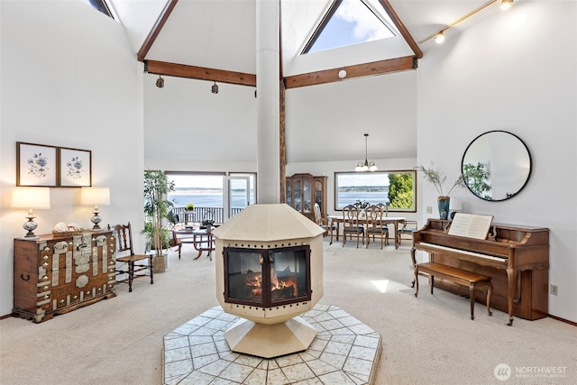 10601 87th Ct, Anderson Island, WA 98303 - living room featuring high vaulted ceiling, light colored carpet, beamed ceiling, and a chandelier