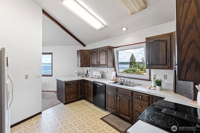 10601 87th Ct, Anderson Island, WA 98303 - kitchen featuring black dishwasher, freestanding refrigerator, plenty of natural light, dark brown cabinetry, and lofted ceiling