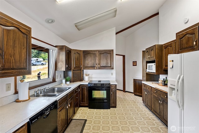 10601 87th Ct, Anderson Island, WA 98303 - kitchen with black appliances, vaulted ceiling, light countertops, dark brown cabinetry, and light flooring