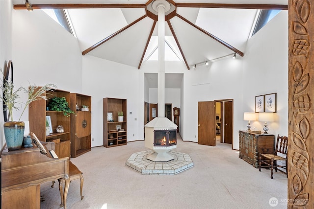 10601 87th Ct, Anderson Island, WA 98303 - living room featuring high vaulted ceiling, carpet floors, a wood stove, and beam ceiling