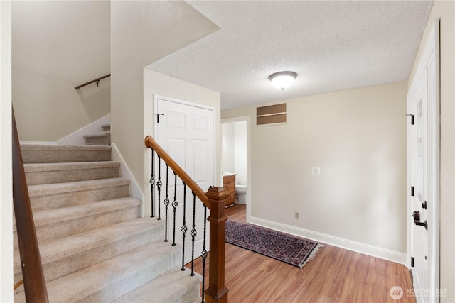 33205 32nd Pl SW, Federal Way, WA 98023 - foyer featuring wood finished floors, baseboards, stairway, and a textured ceiling