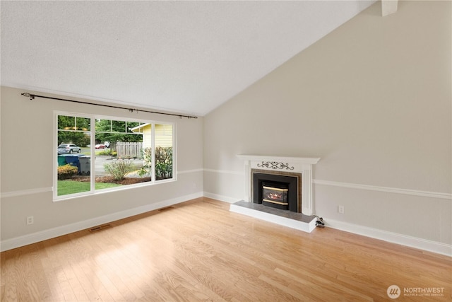 33205 32nd Pl SW, Federal Way, WA 98023 - unfurnished living room featuring wood finished floors, a fireplace, vaulted ceiling, and baseboards