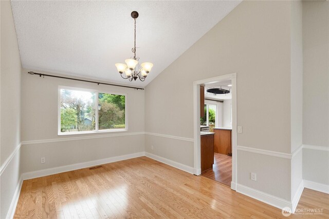 33205 32nd Pl SW, Federal Way, WA 98023 - unfurnished room with a chandelier, light wood-style flooring, vaulted ceiling, and baseboards