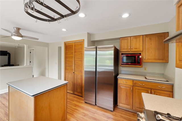 33205 32nd Pl SW, Federal Way, WA 98023 - kitchen featuring freestanding refrigerator, built in microwave, light countertops, light wood-style floors, and a center island