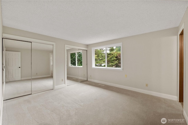 33205 32nd Pl SW, Federal Way, WA 98023 - unfurnished bedroom featuring multiple closets, carpet floors, a textured ceiling, and baseboards