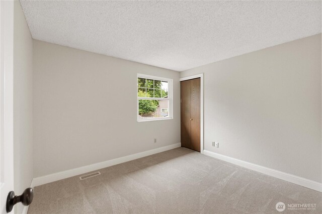 33205 32nd Pl SW, Federal Way, WA 98023 - carpeted empty room featuring baseboards and a textured ceiling