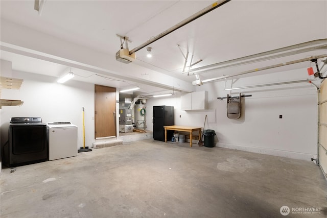 33205 32nd Pl SW, Federal Way, WA 98023 - garage featuring freestanding refrigerator, a garage door opener, and washing machine and dryer