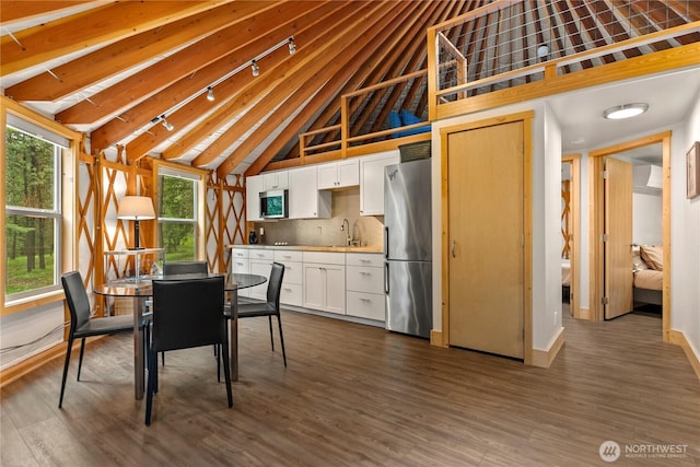 39 Ulrich Ln, Mazama, WA 98833 - unfurnished dining area with dark wood-style flooring, a sink, beamed ceiling, and high vaulted ceiling