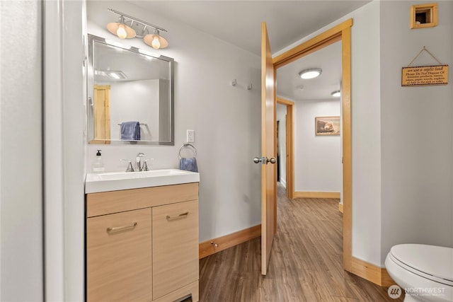39 Ulrich Ln, Mazama, WA 98833 - half bathroom with vanity, wood finished floors, baseboards, and toilet