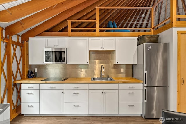 39 Ulrich Ln, Mazama, WA 98833 - kitchen featuring appliances with stainless steel finishes, a sink, butcher block counters, and backsplash