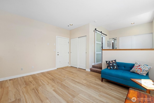 4530 Meridian Ave N Unit S4, Seattle, WA 98103 - living area featuring wood finished floors, a barn door, and recessed lighting