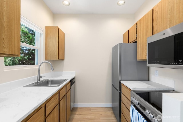 4530 Meridian Ave N Unit S4, Seattle, WA 98103 - kitchen with appliances with stainless steel finishes, light wood finished floors, brown cabinetry, recessed lighting, and light stone counters