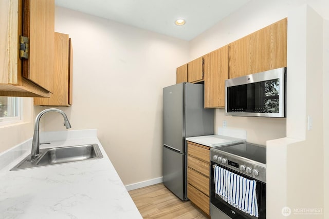 4530 Meridian Ave N Unit S4, Seattle, WA 98103 - kitchen featuring appliances with stainless steel finishes, light countertops, light wood finished floors, brown cabinets, and recessed lighting