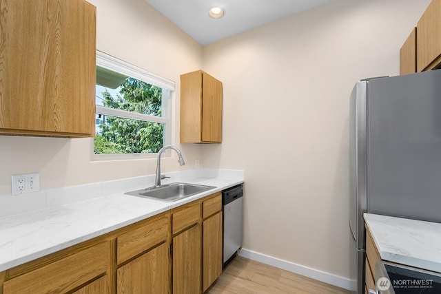 4530 Meridian Ave N Unit S4, Seattle, WA 98103 - kitchen featuring stainless steel appliances, light wood-style floors, brown cabinets, recessed lighting, and light stone countertops