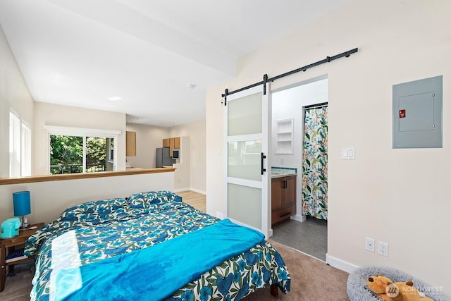 4530 Meridian Ave N Unit S4, Seattle, WA 98103 - bedroom with electric panel, light carpet, a barn door, and freestanding refrigerator