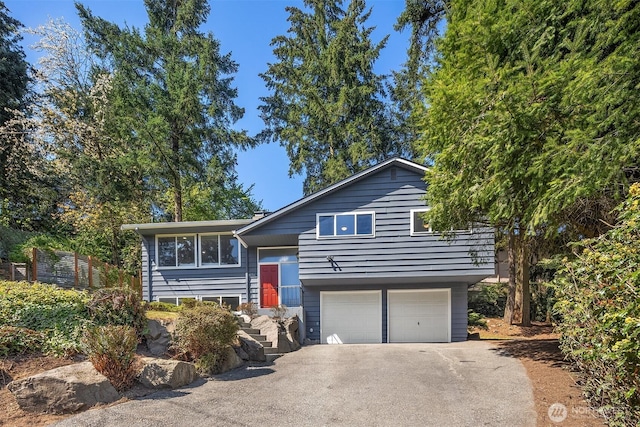 1136 N 146th Pl, Shoreline, WA 98133 - bi-level home featuring driveway and an attached garage